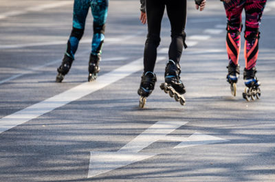 Low section of people skating on road