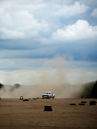 View of car on desert against sky