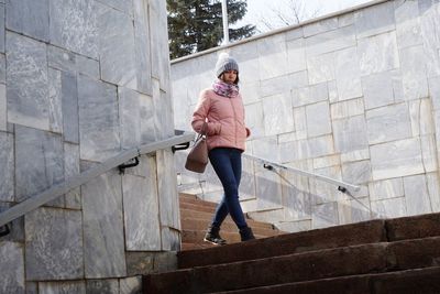 Low angle view of woman moving down on steps