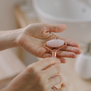 Cropped hand of woman holding jade roller