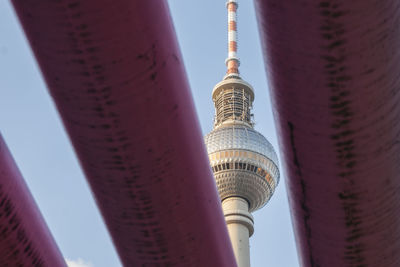 Low angle view of communications tower in city