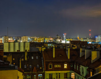 High angle view of illuminated buildings against sky at night