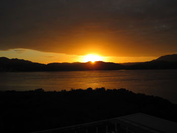 Scenic view of lake against sky during sunset