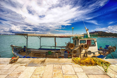 Ship moored at sea shore against sky