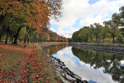 Scenic view of lake by trees against sky during autumn