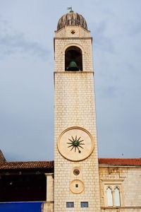 Low angle view of bell tower against sky