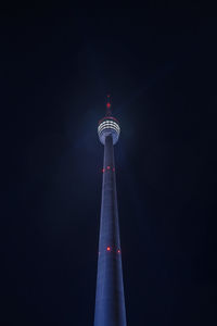 Low angle view of illuminated tower at night