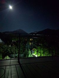 Scenic view of illuminated mountains against sky at night