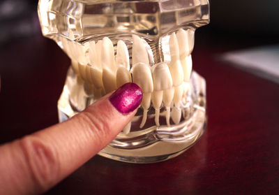 Close-up of woman touching dentures