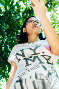 Low angle view of woman looking up