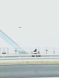 Person riding motorcycle against sky