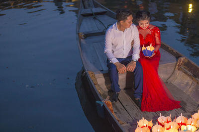 High angle view of people standing by water