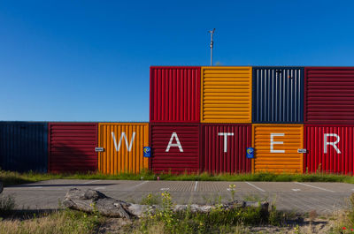 Text on colorful cargo containers