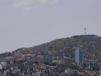 Buildings in city against clear sky