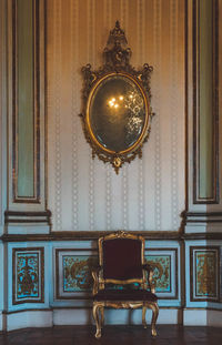 Illuminated chandelier on ceiling of building