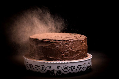 Close-up of cake against black background