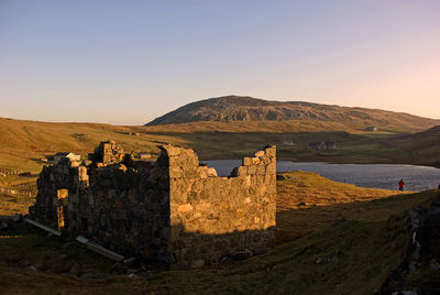 Castle on mountain against clear sky