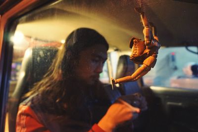 Reflection of man in car