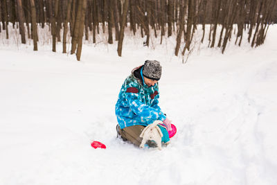 Full length of child on snowy field during winter