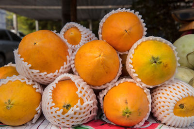 Close-up of oranges on table at market stall