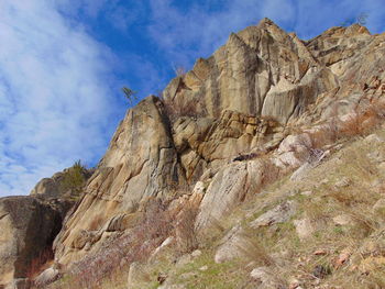 Low angle view of rock formations against sky