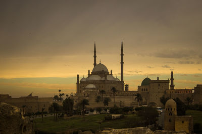 Historical mosque against sky during sunset