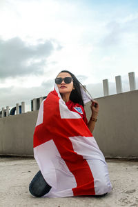 The three lions supporter with england's away kit and flag of st.george cross.