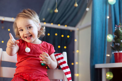 Portrait of cute girl playing with toy at home