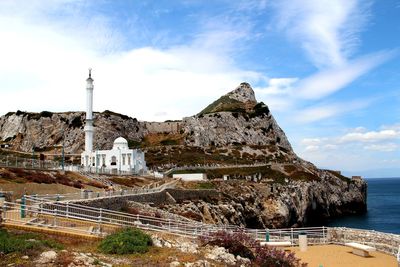 Historic building by sea against sky