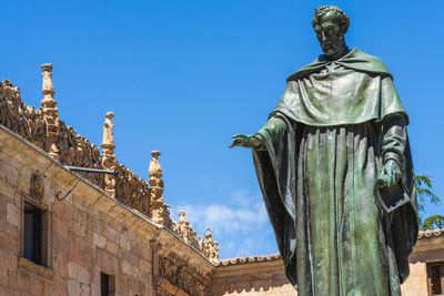 Low angle view of statue against clear blue sky