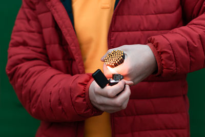 Midsection of woman holding mobile phone