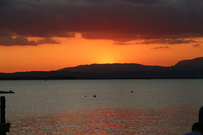 Scenic view of sea against orange sky