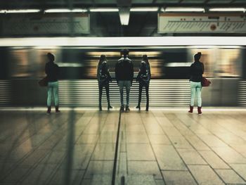 People walking on railroad station platform