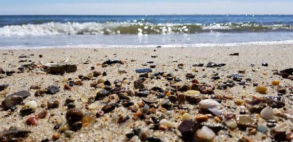 View of pebbles on beach against sky