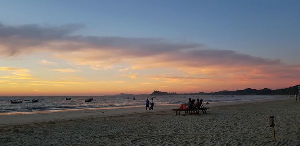 People watching beautiful sunset at ngapali beach in myanmar