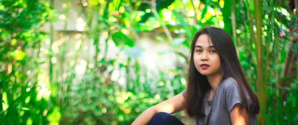 Portrait of beautiful young woman lying on land