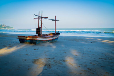 An old fishing boat on the beach with sea background. sea coast line. copy space for text.