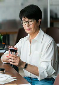 Young woman using mobile phone at restaurant