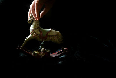 Low section of man wearing mask against black background