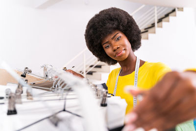 Close-up of fashion designer working at studio