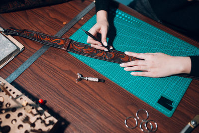 Cropped image of young fashion designer working at workshop