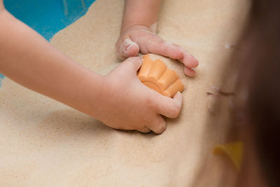 High angle view of woman hand on cutting board