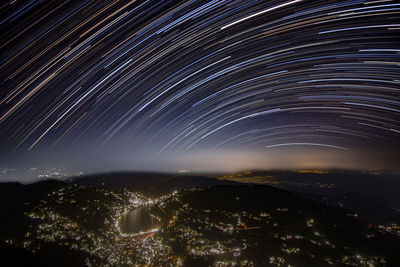 Aerial view of illuminated city against sky at night