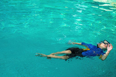 High angle view of woman swimming in sea