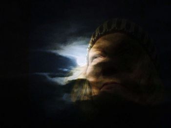 Close-up of man against black background