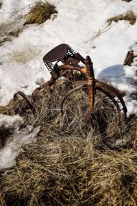 Abandoned bicycle on snow covered field