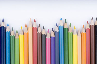 Close-up of colored pencils against white background