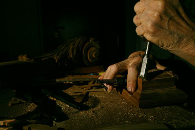 Cropped hand of man working at home