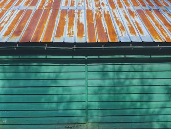 Rusted roof and green wood