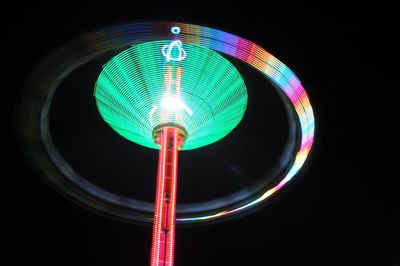 Low angle view of illuminated lights at night